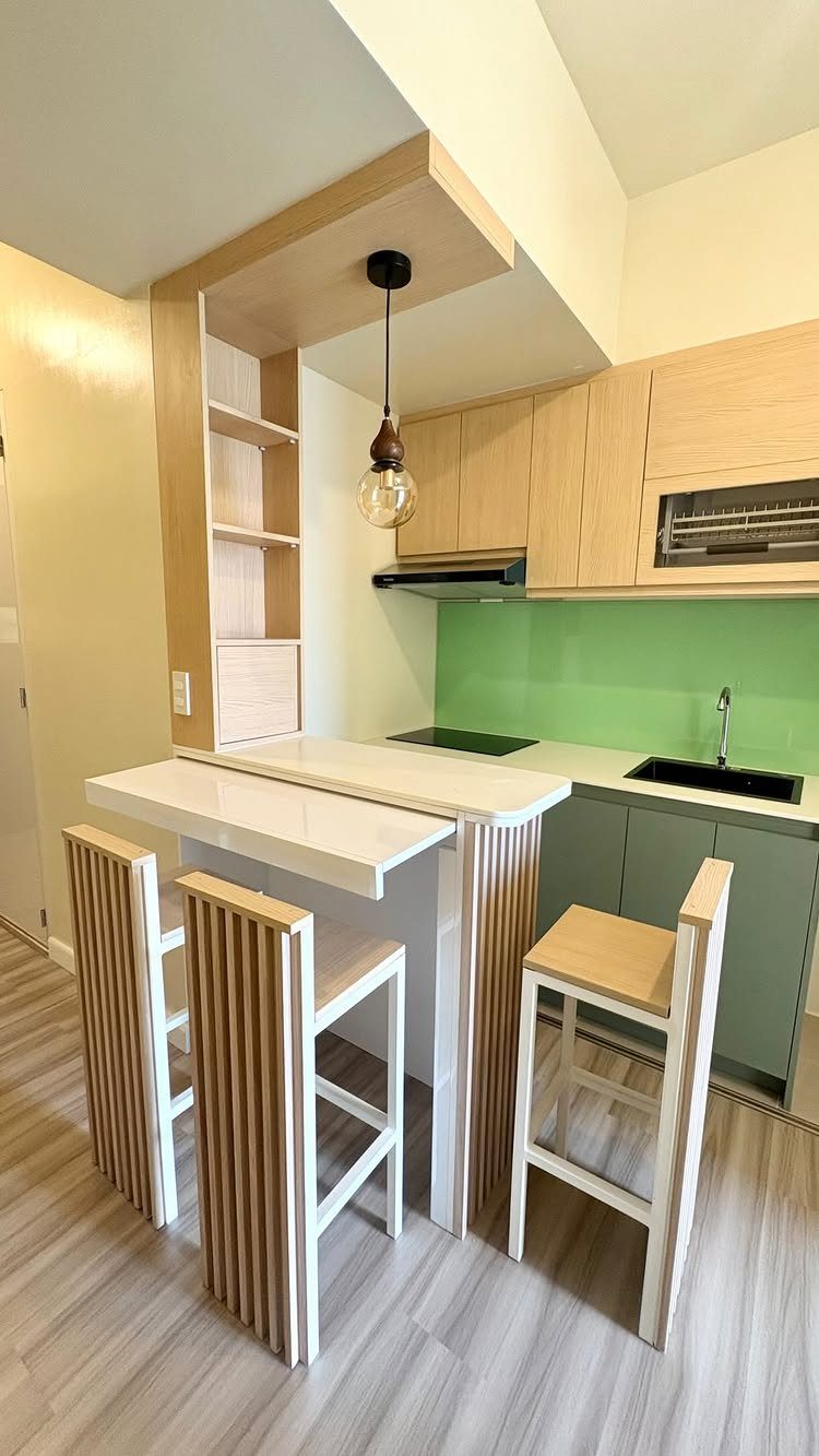 19 Small Kitchen Reno Ideas That Maximize Every Inch 20 Small kitchen with light wood cabinets, green backsplash, and white breakfast bar stools.