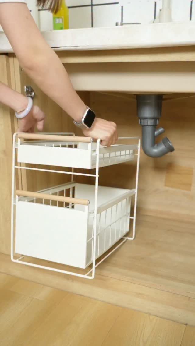 19 Small Kitchen Reno Ideas That Maximize Every Inch 19 Two-tier white sliding storage rack pulled out from under a kitchen sink.