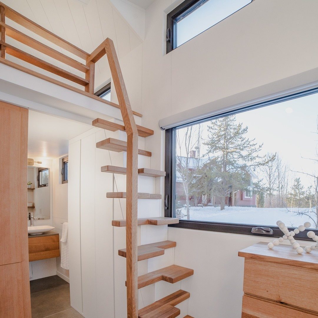 Tiny House Layout Ideas: 27 Smart Ways to Maximize Space 27 Wooden open-tread stairs leading to a loft in a bright tiny house interior.