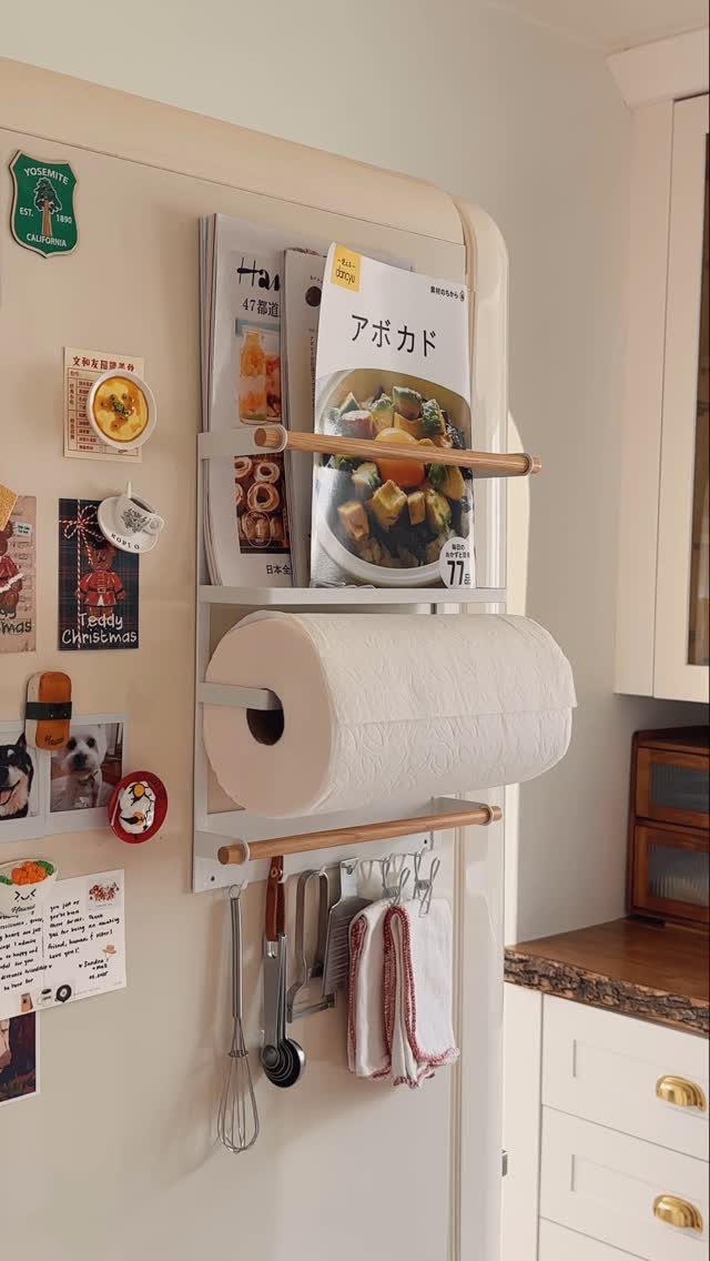 Tiny House Layout Ideas: 27 Smart Ways to Maximize Space 22 Refrigerator door with a white organizer holding cookbooks, paper towels, and kitchen utensils.